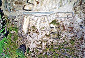 Aerial photo of a part of the site. The main entrance and the rising paved are visible, on either side of which the bouleuterion and the granary stand.